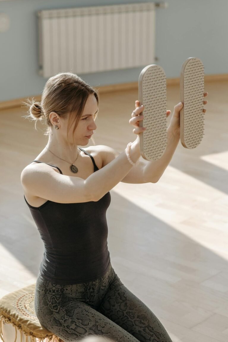 Woman indoors balancing equipment, focusing on mindful practice and wellness.